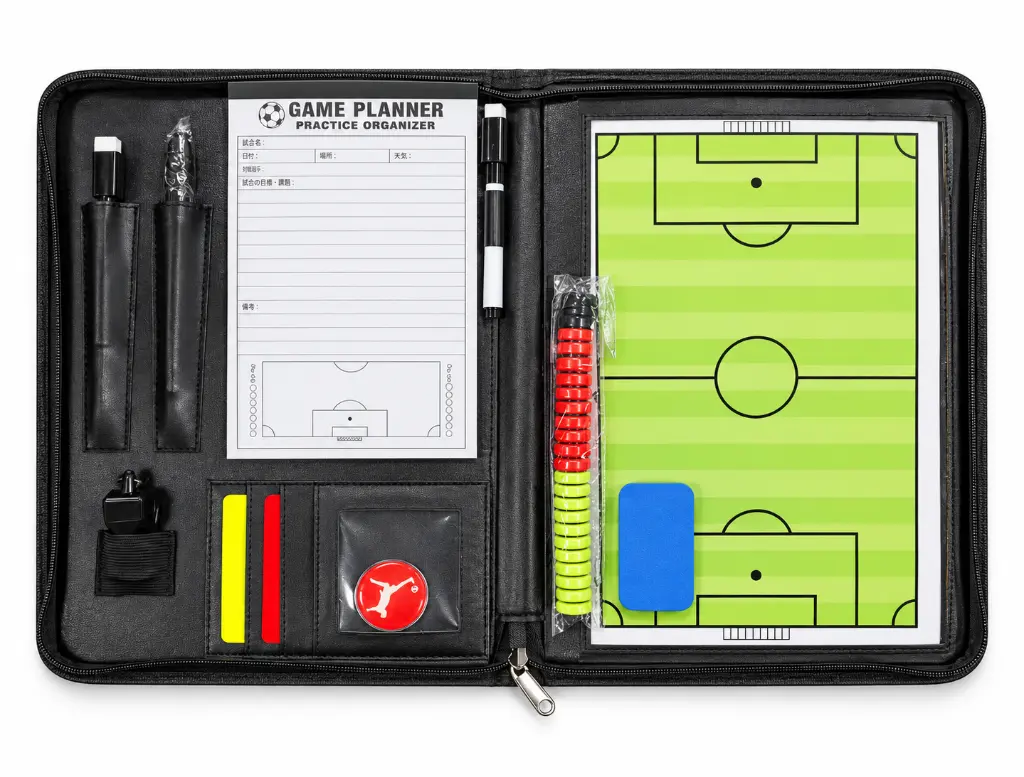 Open football coaching folio with tactics board.webp