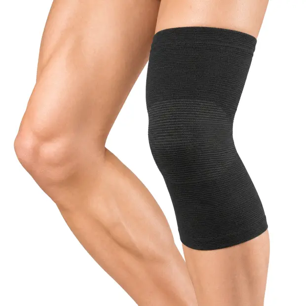 Black knee support on bent legs.webp